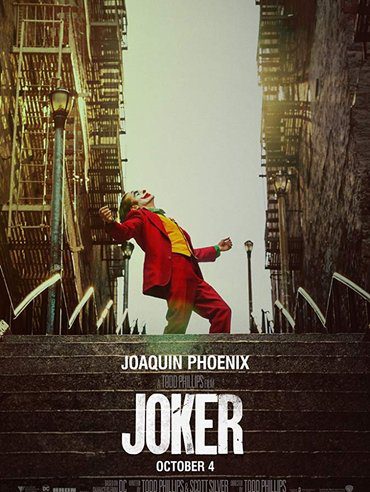 Joaquin Phoenix as Joker dancing on stairs in a gritty urban setting.