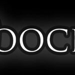 Close-up of the word 'DOCK' with a dark background.
